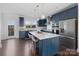 Modern kitchen featuring navy cabinets, white countertops, stainless steel appliances, and a functional kitchen island at 11039 Stetler St, Charlotte, NC 28204
