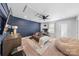 Comfortable living room with navy accent wall, ceiling fan, plush seating and carpet at 11039 Stetler St, Charlotte, NC 28204