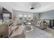 Bright living room features large windows, hardwood floors, and an open layout with a cozy sectional sofa at 11039 Stetler St, Charlotte, NC 28204