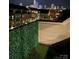 View of city skyline from rooftop deck featuring a green privacy wall and artificial grass at 11039 Stetler St, Charlotte, NC 28204