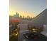 Outdoor seating area with chairs, fire pit, and skyline views at 11039 Stetler St, Charlotte, NC 28204