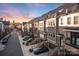 Street view of modern townhomes with brick and gray siding, featuring private garages and entry stairs at 11039 Stetler St, Charlotte, NC 28204