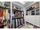 Well-organized walk-in closet with ample shelving, rods, and storage drawers at 11039 Stetler St, Charlotte, NC 28204