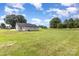 Large, grassy backyard showcasing the back of the house and surrounding trees at 115 Frances St, Salisbury, NC 28147