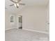 An inviting carpeted bedroom features a ceiling fan and an ensuite bathroom at 115 Frances St, Salisbury, NC 28147