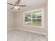 Neutral bedroom with a ceiling fan, window, and plush carpeting at 115 Frances St, Salisbury, NC 28147