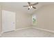 Vaulted ceiling with fan accents this carpeted room, featuring a window and door at 115 Frances St, Salisbury, NC 28147