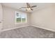 Inviting bedroom features a ceiling fan, window, and soft carpeting at 115 Frances St, Salisbury, NC 28147