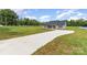 Scenic exterior of a single-story home with gray siding and a large front yard with a long driveway at 115 Frances St, Salisbury, NC 28147