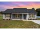 Charming single-story home featuring gray siding, a dark shingle roof, and a well-maintained front lawn at 115 Frances St, Salisbury, NC 28147