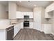 A modern kitchen features white cabinets, stainless steel appliances, and granite countertops at 115 Frances St, Salisbury, NC 28147