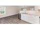 Kitchen boasts stainless appliances, granite counters, and an open layout to the living area at 115 Frances St, Salisbury, NC 28147