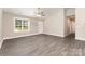 Bright living room with vaulted ceilings, ceiling fan, gray wood-look flooring, and natural light from the window at 115 Frances St, Salisbury, NC 28147