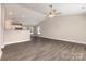 Bright and spacious living room featuring gray wood-look flooring and a view into the modern, white kitchen at 115 Frances St, Salisbury, NC 28147