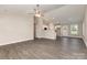 Open-concept living room with gray wood-look flooring, a ceiling fan, and a view into the modern kitchen at 115 Frances St, Salisbury, NC 28147
