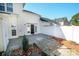 Well-maintained backyard with a concrete patio, mulch areas, and a white fence, perfect for outdoor enjoyment at 11630 Lioness St, Charlotte, NC 28273
