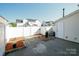 Enclosed backyard featuring a concrete patio, wood mulch, and a white fence, offering a private outdoor space at 11630 Lioness St, Charlotte, NC 28273
