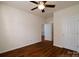 Comfortable bedroom with wood floors, neutral walls, a ceiling fan, and a closet for storage at 11630 Lioness St, Charlotte, NC 28273
