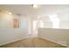 Bright living room boasts neutral walls, carpet, and doorways leading to other rooms, enhanced with recessed lighting at 11630 Lioness St, Charlotte, NC 28273