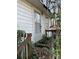 A back door surrounded by ivy and a wooden porch is overgrown at 119 Lineberger St, Stanley, NC 28164