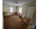 A view of a bedroom with an aged floor, window, and door frame showcases its size and layout at 119 Lineberger St, Stanley, NC 28164