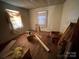 This bedroom is messy and has aged hard wood floors at 119 Lineberger St, Stanley, NC 28164