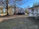 This property shows a partial view of a house from the lawn, with a house in the background at 119 Lineberger St, Stanley, NC 28164