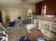 A messy kitchen has a partial cabinet, oven, toilet, and other belongings at 119 Lineberger St, Stanley, NC 28164