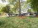 Large backyard featuring a guesthouse, mature trees, and well-maintained lawn offering a private outdoor oasis at 1310 Woodland Dr, Charlotte, NC 28205
