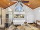 Bathroom featuring a claw foot tub, glass shower, slate tile, a wood ceiling, and a vaulted arch window at 1310 Woodland Dr, Charlotte, NC 28205