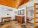 Stylish bathroom with dual vanity, wood ceiling, stone floors, and adjacent bedroom at 1310 Woodland Dr, Charlotte, NC 28205