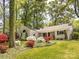 Beautiful home with lush landscaping and a well-manicured lawn at 1310 Woodland Dr, Charlotte, NC 28205