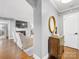 Bright foyer with hardwood floors, gray walls, and decoratively appointed wooden side table at 1310 Woodland Dr, Charlotte, NC 28205