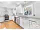 Bright kitchen boasts stainless appliances, granite counters, white cabinets, and a window over the sink at 1310 Woodland Dr, Charlotte, NC 28205