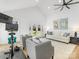Bright living room with high ceiling, ceiling fan, modern art, and an exercise bike at 1310 Woodland Dr, Charlotte, NC 28205