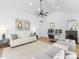 Bright living room featuring a high ceiling, modern art, comfortable seating, and hardwood floors at 1310 Woodland Dr, Charlotte, NC 28205