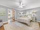 Bedroom view featuring a ceiling fan, gray walls, light carpet, and access to the bathroom at 1310 Woodland Dr, Charlotte, NC 28205
