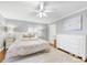 Bedroom boasting soft light, ceiling fan, gray walls, light carpet, and a dresser at 1310 Woodland Dr, Charlotte, NC 28205