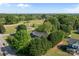 A lovely aerial view shows a home nestled among mature trees, surrounded by a large grassy area at 139 Fort Dobbs Rd, Statesville, NC 28625