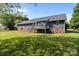 This is the back exterior of this home, with a deck, a nice lawn, and lots of trees at 139 Fort Dobbs Rd, Statesville, NC 28625