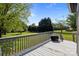 This backyard has a deck area, green lawn, large trees, and a clear blue sky at 139 Fort Dobbs Rd, Statesville, NC 28625