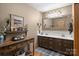 This bathroom features double sinks, warm paint, decor, wood cabinets, a large mirror, and a vanity at 139 Fort Dobbs Rd, Statesville, NC 28625