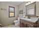 This bathroom features a single sink, wood cabinets, a window, tile floors, and neutral paint at 139 Fort Dobbs Rd, Statesville, NC 28625