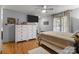 Cozy bedroom with wood floors features a queen bed, dressers, and a view of the backyard at 139 Fort Dobbs Rd, Statesville, NC 28625