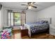 This bedroom has hardwood floors, one window, a ceiling fan, and is decorated with toys at 139 Fort Dobbs Rd, Statesville, NC 28625