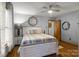 This bedroom features hardwood floors, ceiling fan, and a view of the backyard for a tranquil experience at 139 Fort Dobbs Rd, Statesville, NC 28625