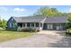 An inviting single-story home featuring a landscaped front yard and a gravel driveway at 139 Fort Dobbs Rd, Statesville, NC 28625