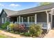 Inviting front porch with white railing, plants and shrubbery at 139 Fort Dobbs Rd, Statesville, NC 28625