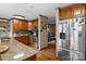 Updated kitchen with stainless steel refrigerator, granite countertops, and wood cabinets offers space and style at 139 Fort Dobbs Rd, Statesville, NC 28625