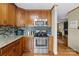 A well-equipped kitchen includes stainless steel oven, microwave, and beautiful backsplash complemented by wooden cabinets at 139 Fort Dobbs Rd, Statesville, NC 28625